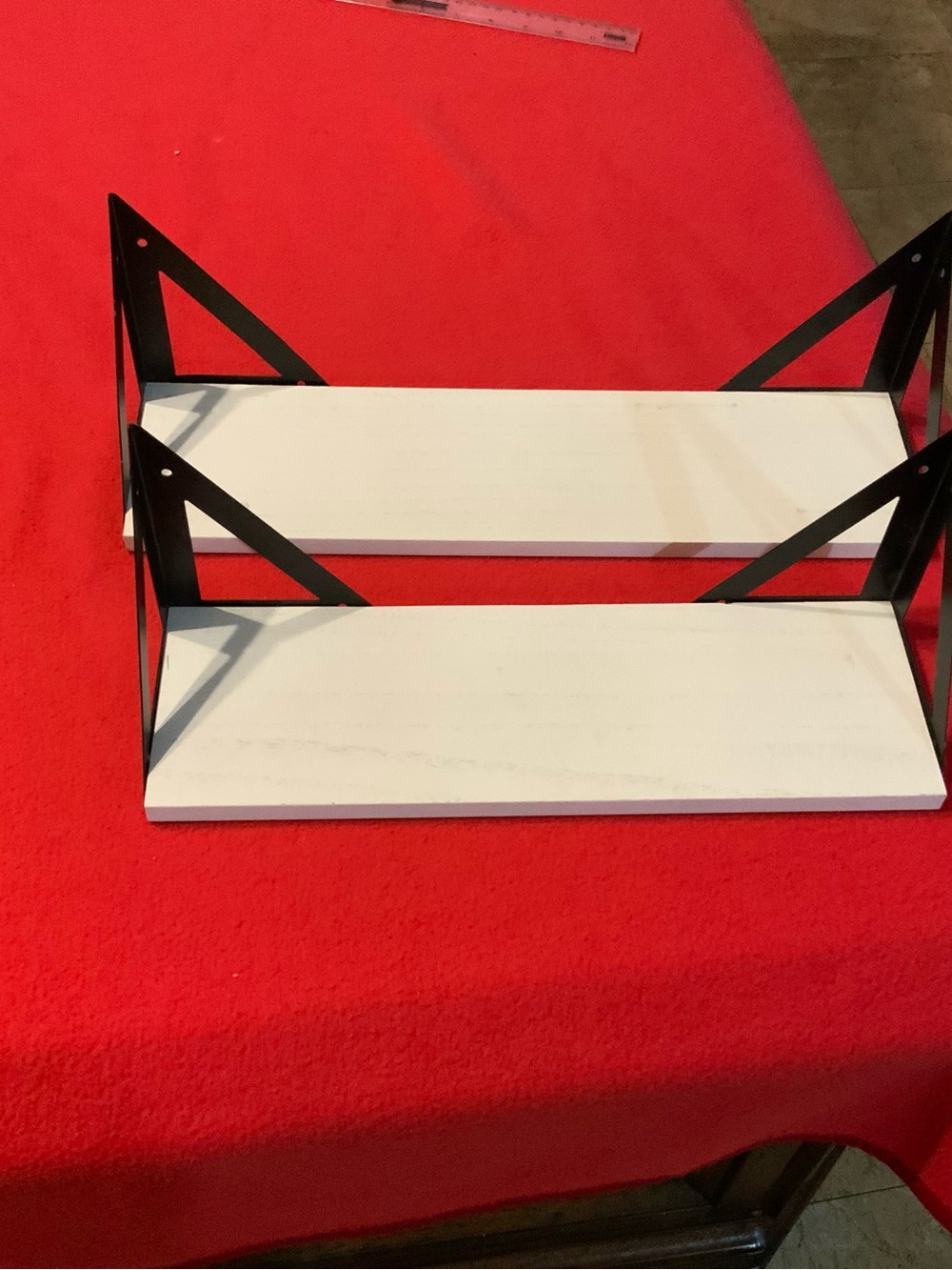 set of two white wooden wall-mounted floating shelves